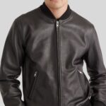 Close-up of men's black leather bomber jacket material and details