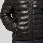 Close-up view of the details on a men's black leather puffer jacket