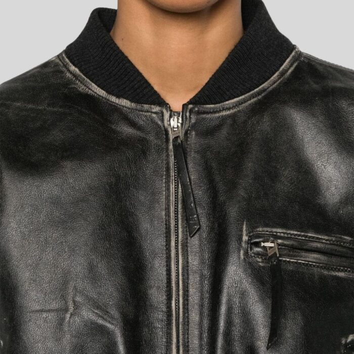 Close-up of distressed leather bomber jacket details for women