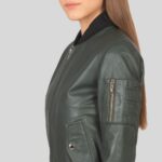 Close-up view of a women's green bomber jacket