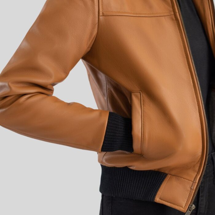 Close-up view of women's leather bomber jacket with hood